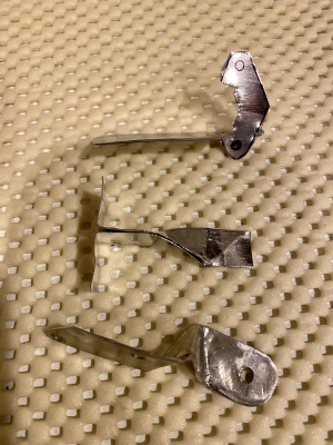 a series of thermal-sensor bracket-prototypes. These feature folded coffee-can metal, which is then soldered for additional thickness and rigidity.